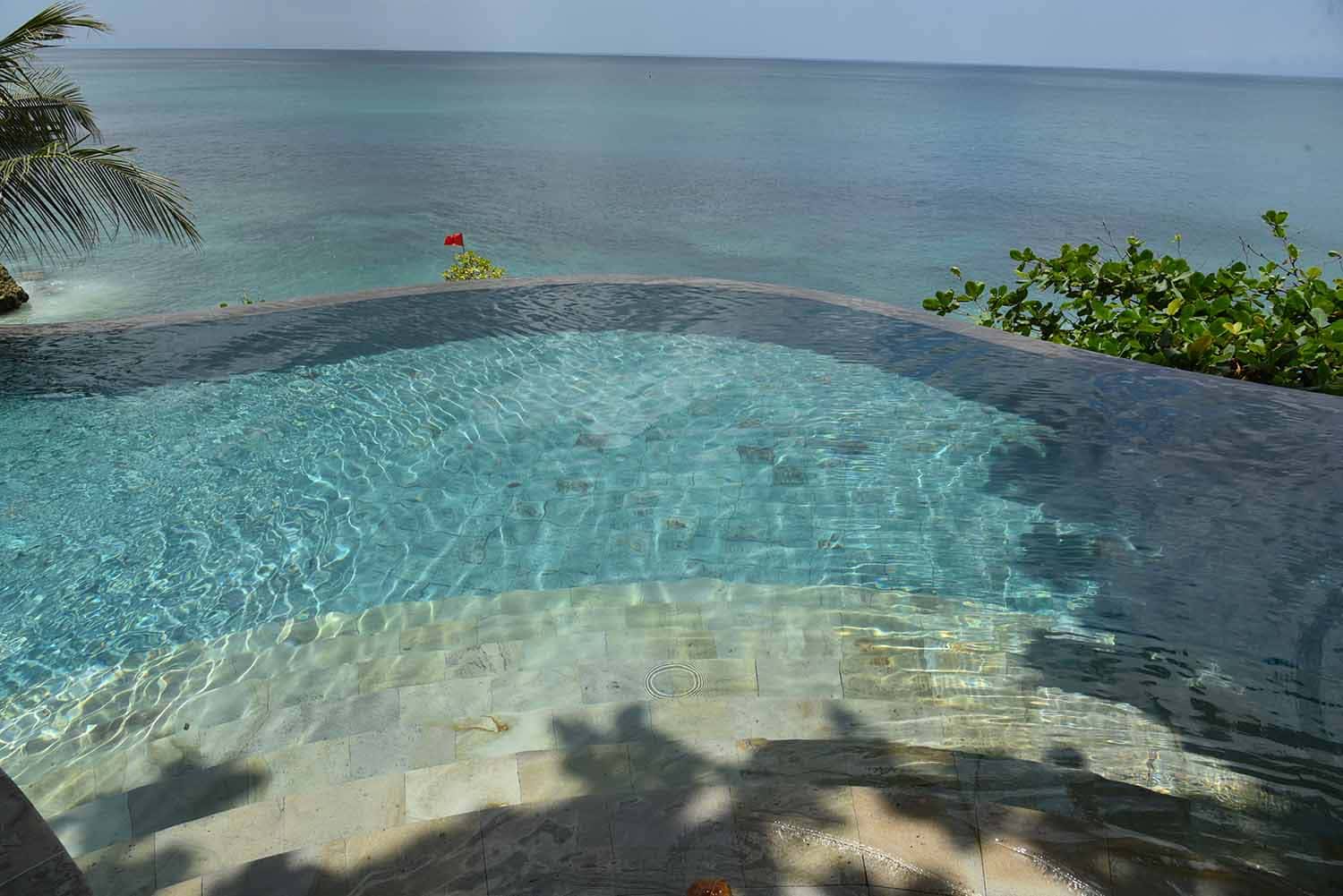 Luxury swimming pool finished with authentic Green Sukabumi Stone by Golden Isla Tile